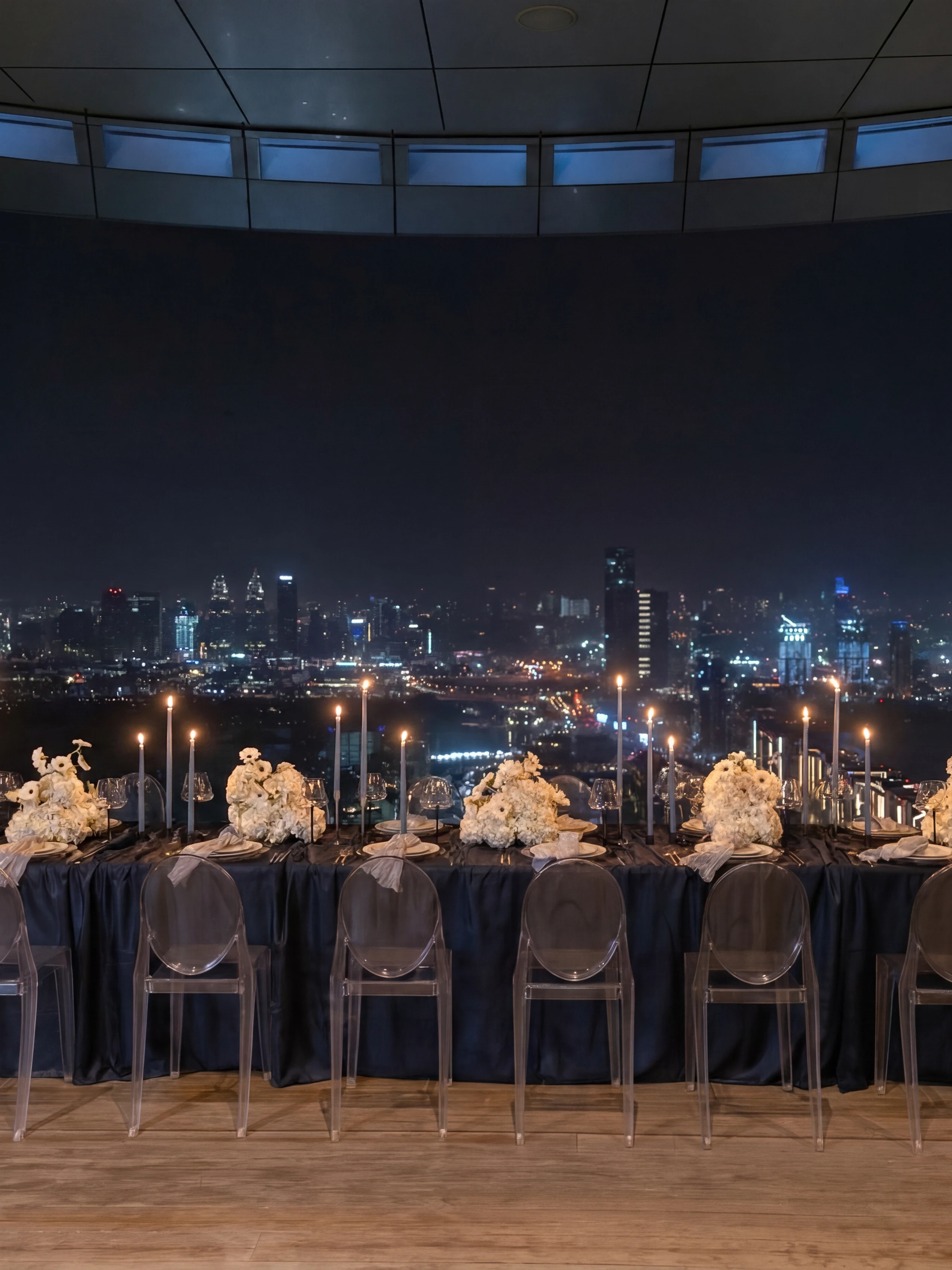 Blue Night editorial at Aura Sky Pool, Dubai: candlelit rooftop table at night with the city skyline glowing beyond in deep blue light